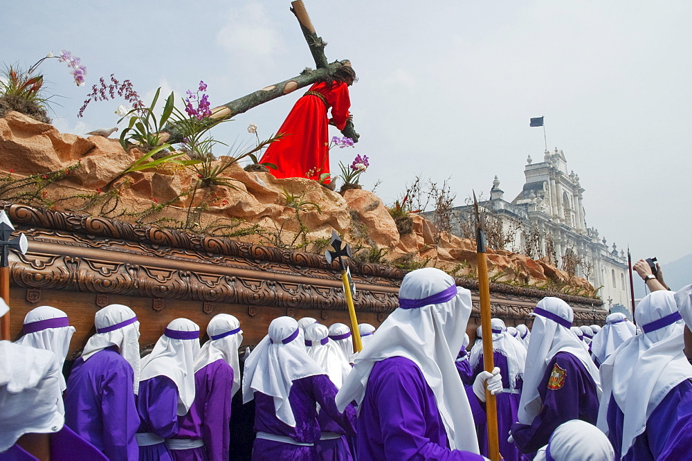 Men carrying the anda (float) of Jesus carrying the Cross during the Procession of the Holy Cross on Good Friday in Antigua Guatemala, Sacatepuquez, Guatemala