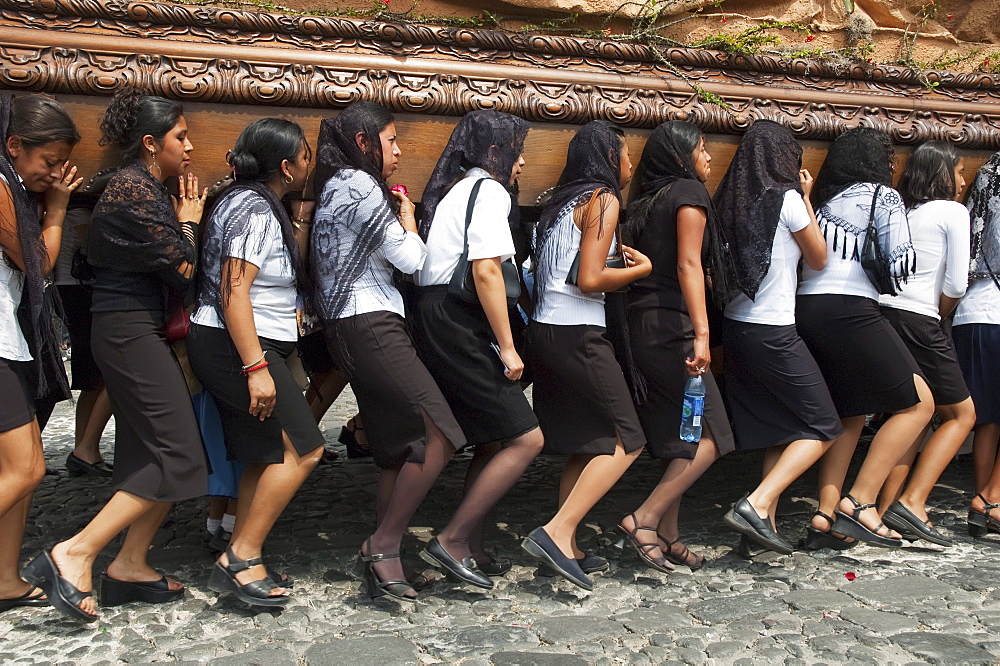 Women dressed in mourning carry the anda (float) of the sorrowful Virgin Mary during a Good Friday Procession in Antigua Guatemala, Sacatepuquez, Guatemala