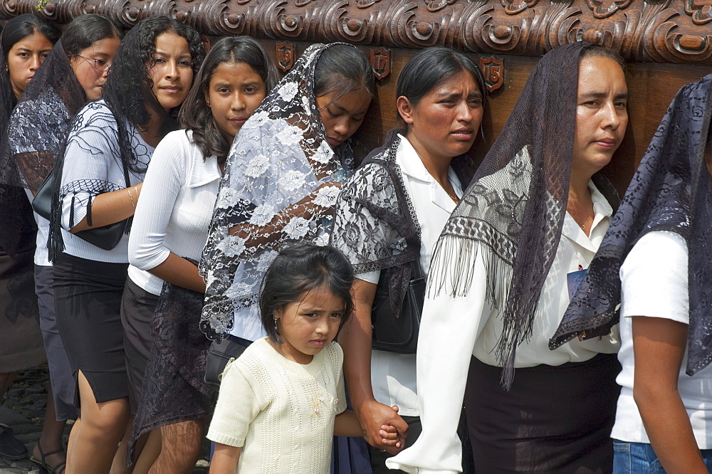 Women dressed in mourning carry the anda (float) of the sorrowful Virgin Mary during a Good Friday Procession in Antigua Guatemala, Sacatepuquez, Guatemala