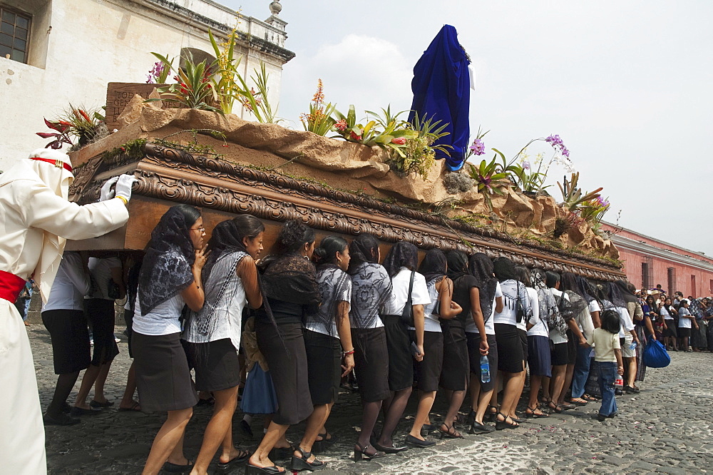 Women dressed in mourning carry the anda (float) of the sorrowful Virgin Mary during a Good Friday Procession in Antigua Guatemala, Sacatepuquez, Guatemala