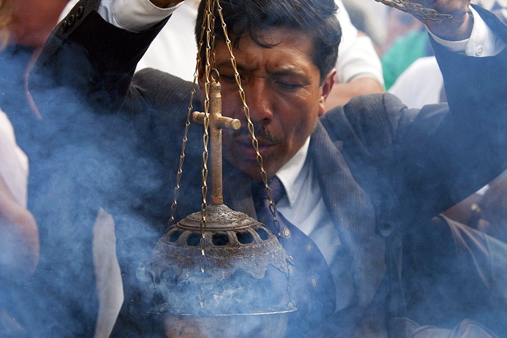 Man waiving an incense burner during the Holy Burial Procession on Good Friday in Antigua Guatemala, Sacatepuquez, Guatemala