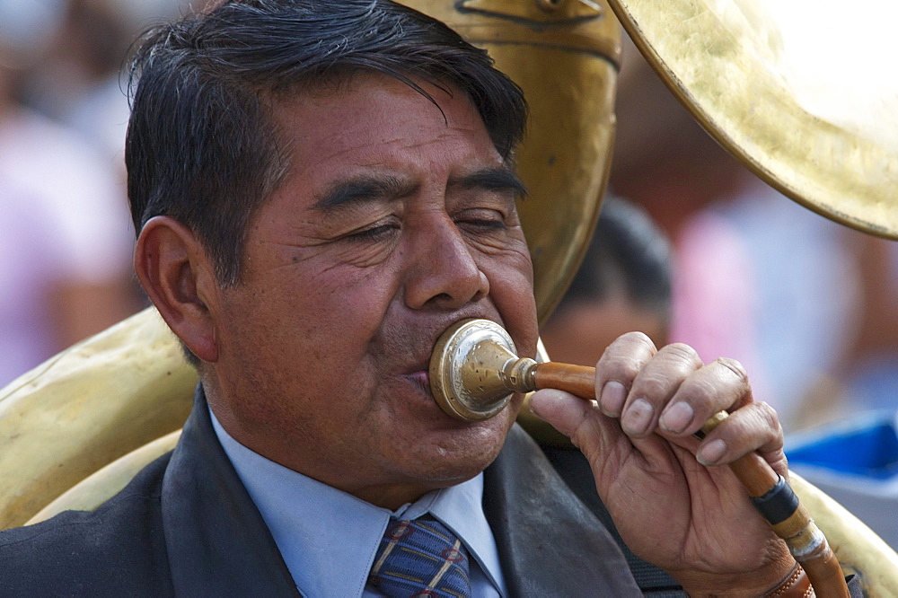 Tuba player playing funeral marches at the Holy Burial Procession on Good Friday in Antigua Guatemala, Sacatepuquez, Guatemala