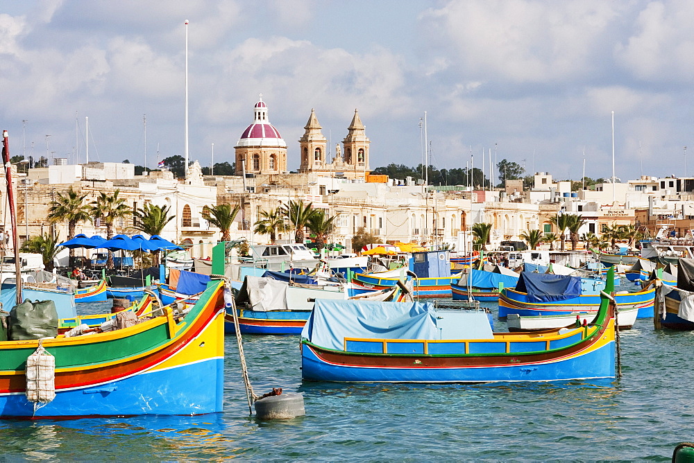 Luzzus, traditional Maltese fishing boats in the harbour, Marsaxlokk, Malta