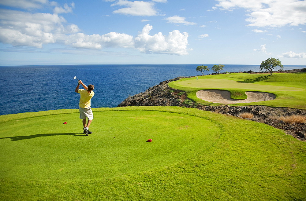 Hawaii, Lanai, Man playing golf at The Challenge at Manele Golf Course.