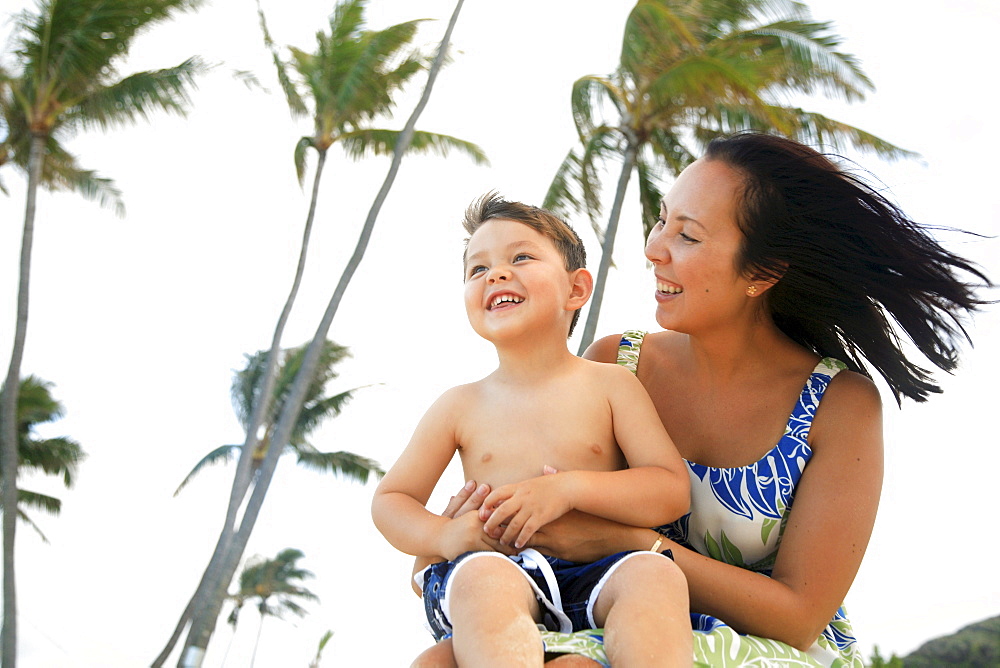 Hawaii, Oahu, A happy mother interacting with her son.