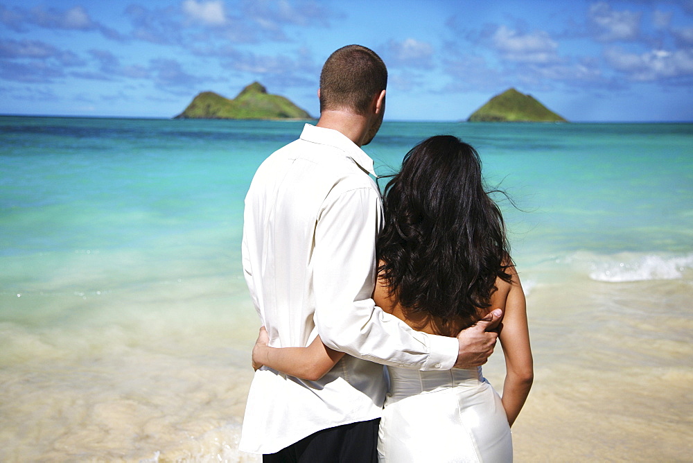 Oahu, Hawaii, Lanikai, Young couple both holding eachother.