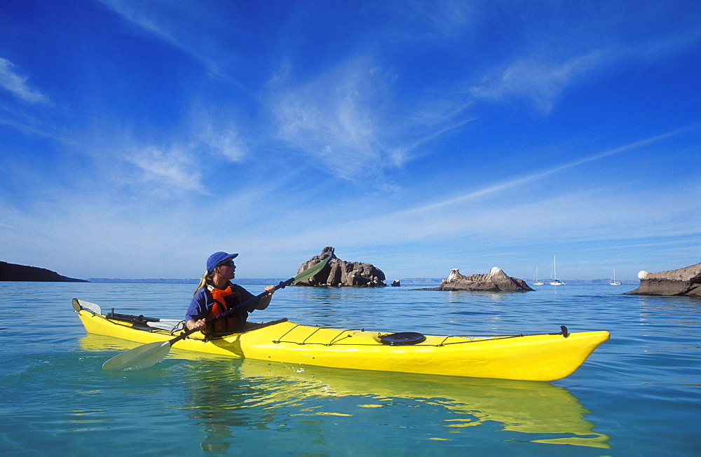 Mexico, Baja California Sur, Sea of Cortez at Espiritu Santo Island near La Paz, Woman sea kayaking.