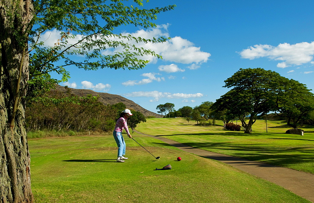 Hawaii, Oahu, Waianae, Makaha Resort, A Korean woman enjoys playing the 15th hole.