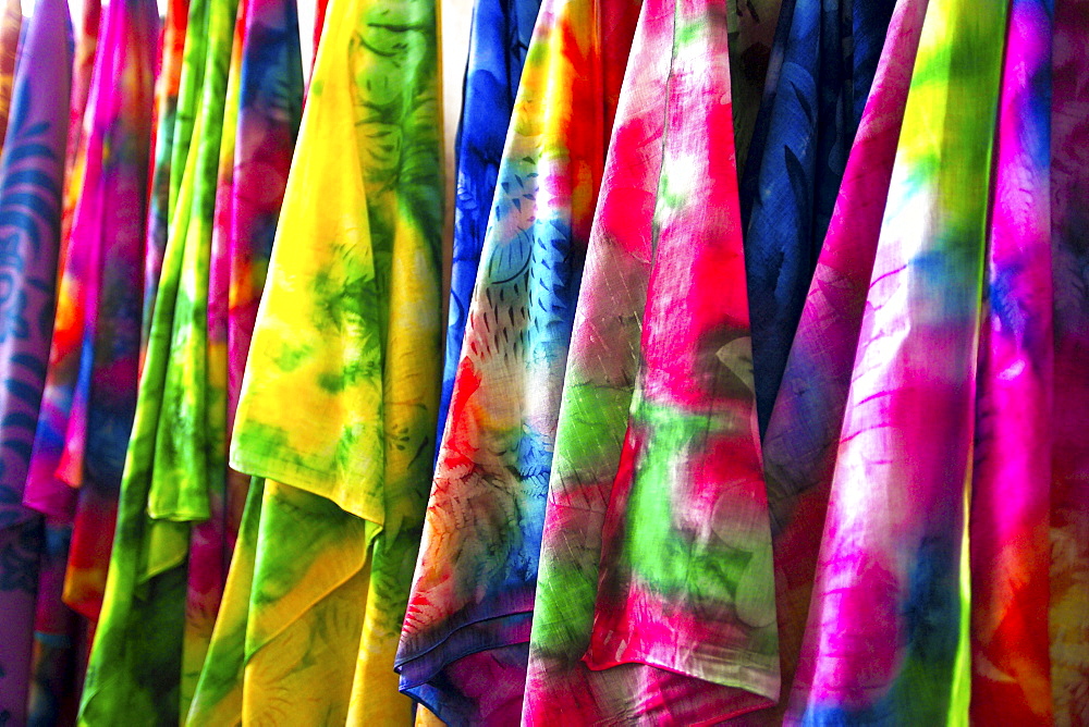 French Polynesia, Tahiti, Papeete, closeup of many colorful pareos for sale at market