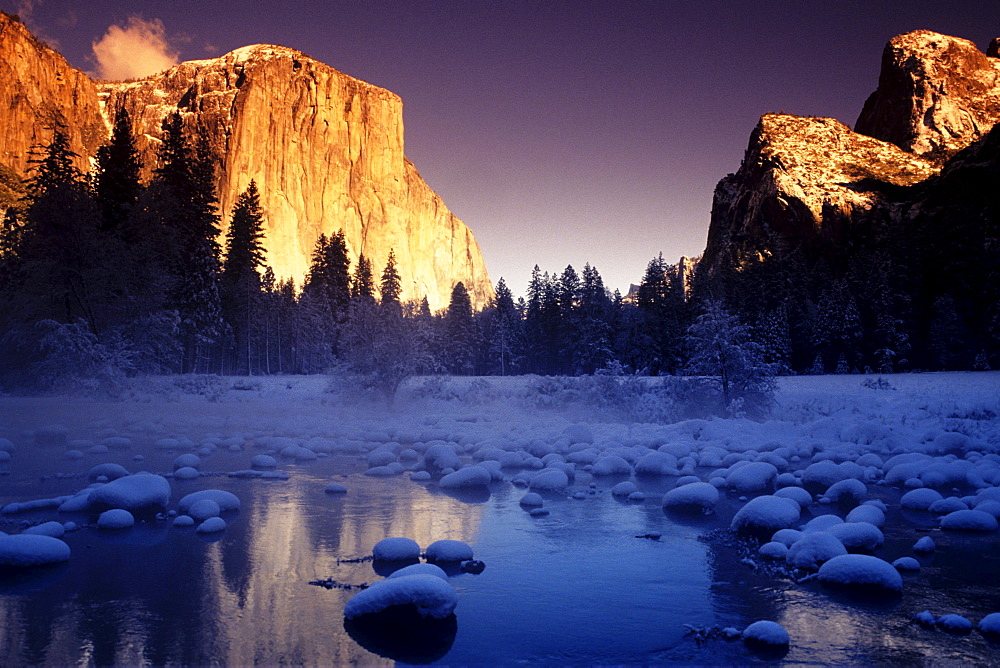 California, Yosemite National Park, Yosemite Valley, Sunset over El Capitan and snowy Merced River.