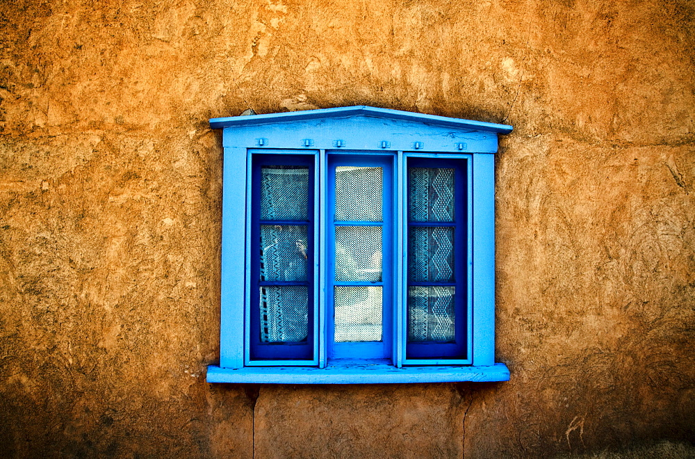 Northern New Mexican Windows, New Mexico, Blue deep-seated window on adobe wall.