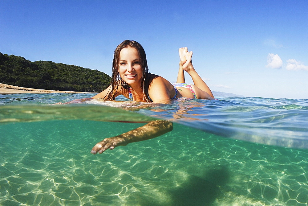 Hawaii, Oahu, Beautiful surfer girl in the ocean.