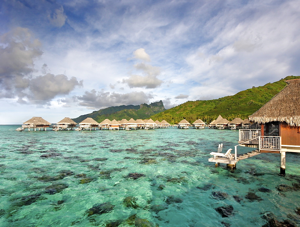 French Polynesia, Moorea Lagoon Resort, Bungalows over beautiful turquoise ocean.