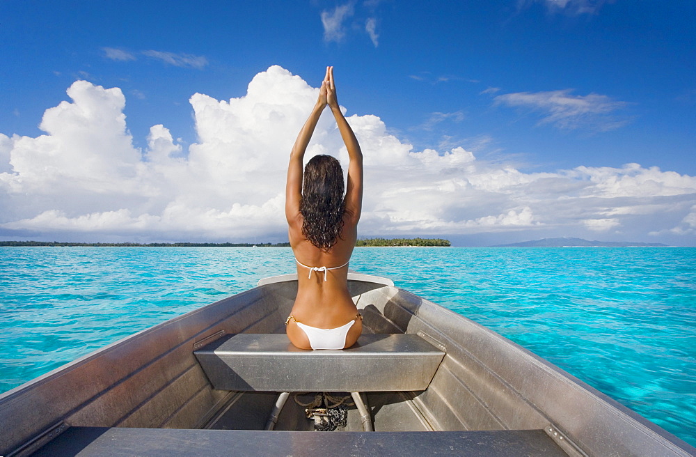 French Polynesia, Tahiti, Bora Bora, Woman sitting in boat.