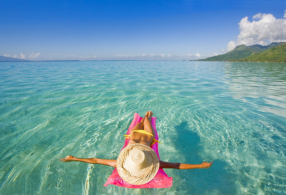 French Polynesia, Tahiti, Moorea, Woman floating in water.