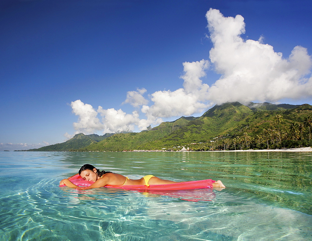 French Polynesia, Tahiti, Moorea, Woman floating in water.