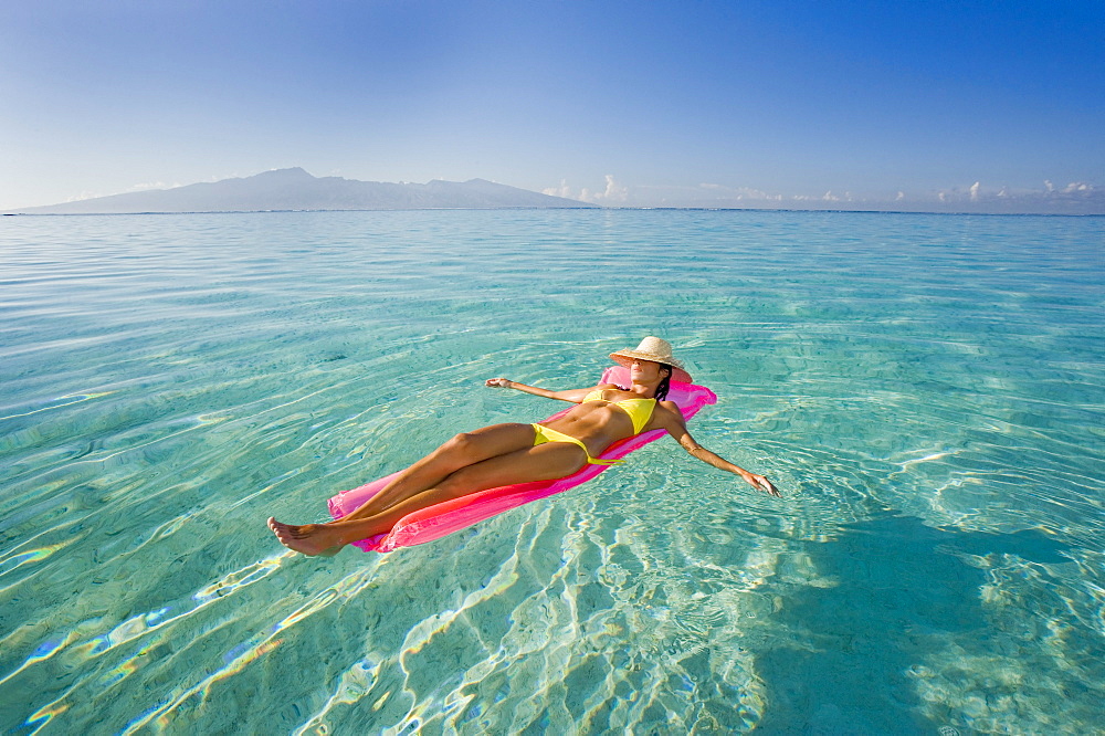 French Polynesia, Tahiti, Moorea, Woman floating in water.