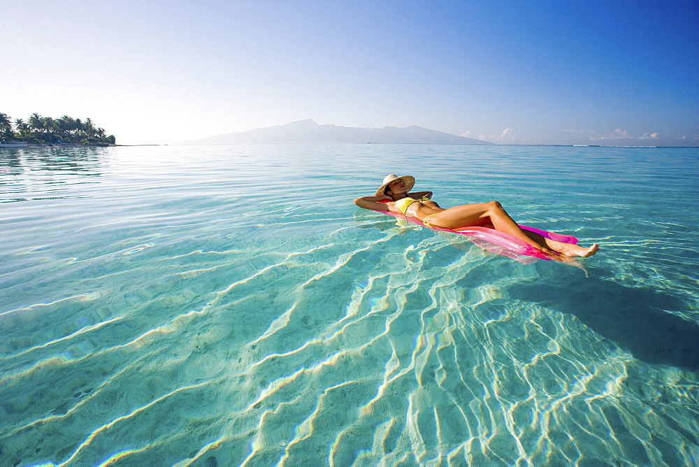 French Polynesia, Tahiti, Moorea, Woman floating in water.