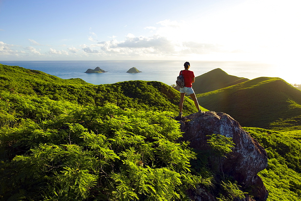 Hawaii, Oahu, Lanikai, Woman hiker admiring view of Mokulua Islands.