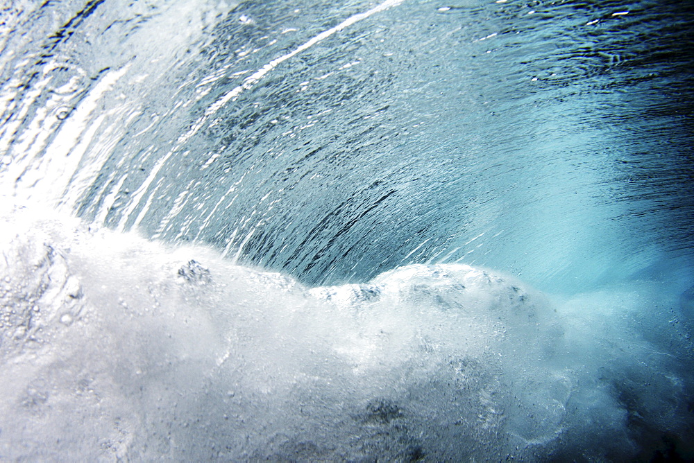 Hawaii, crashing blue underwater wave.