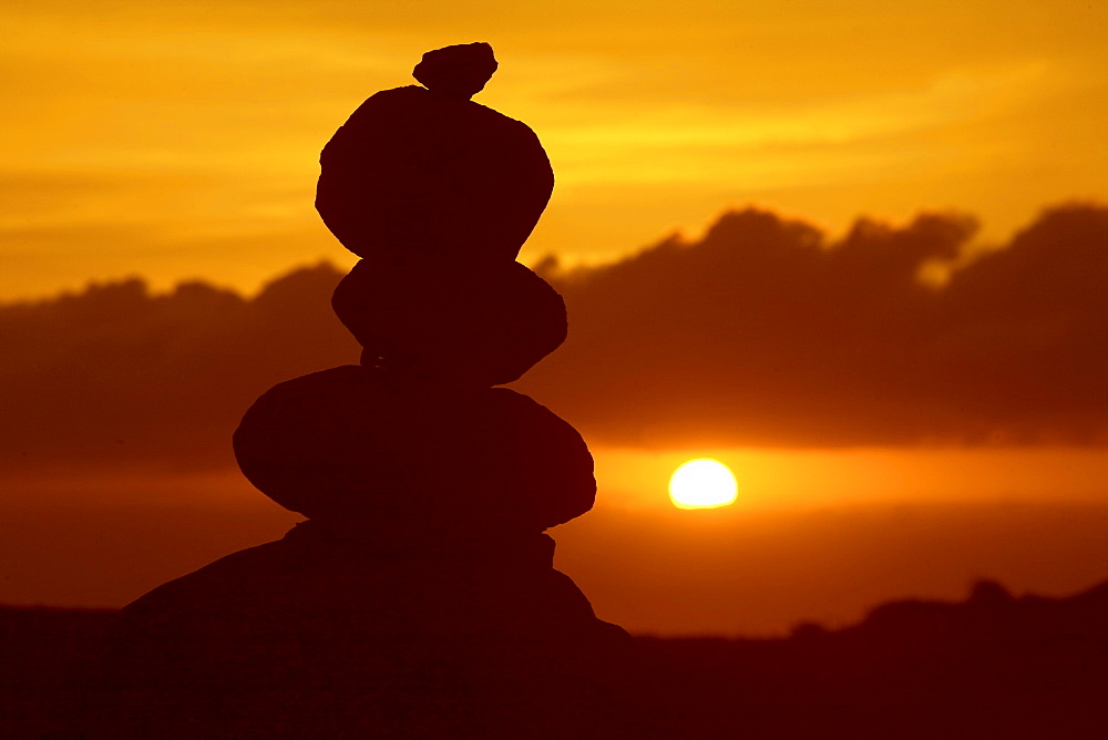 Hawaii, Lanai, Garden of the Gods, pile of rocks silhouetted by dramatic sunset.