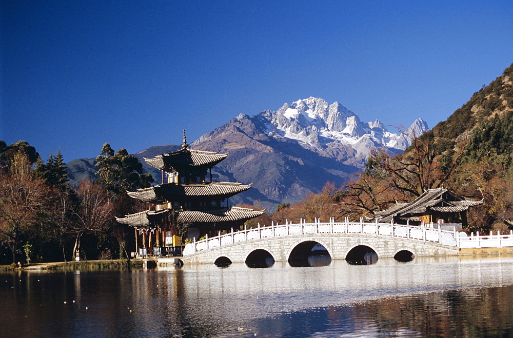 China, Lijang, Black Dragon Pool Park, Five Phoenix Pavilion, bridge and pagoda.