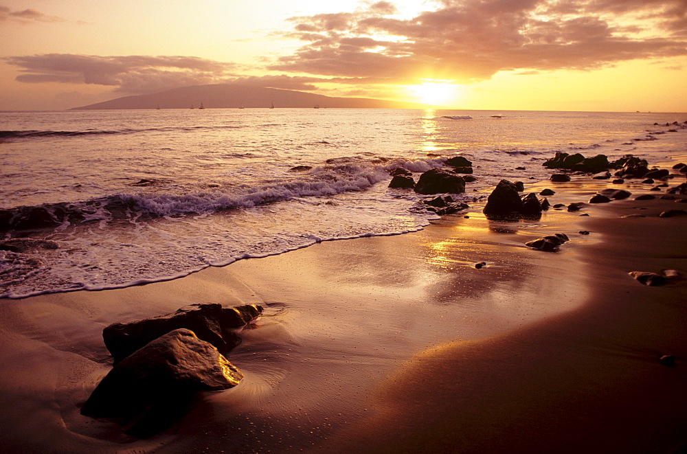 Hawaii, Sunset over beach landscape, Waves breaking on shoreline.