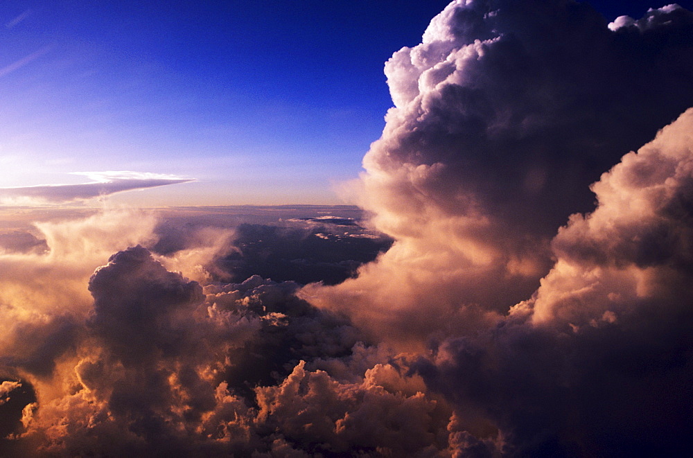 Beautiful pink light from sunset glowing on storm clouds.