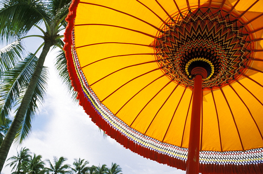 Indonesia, Bali, Nusa Dua hotel, View from below of yellow patio umbrella.