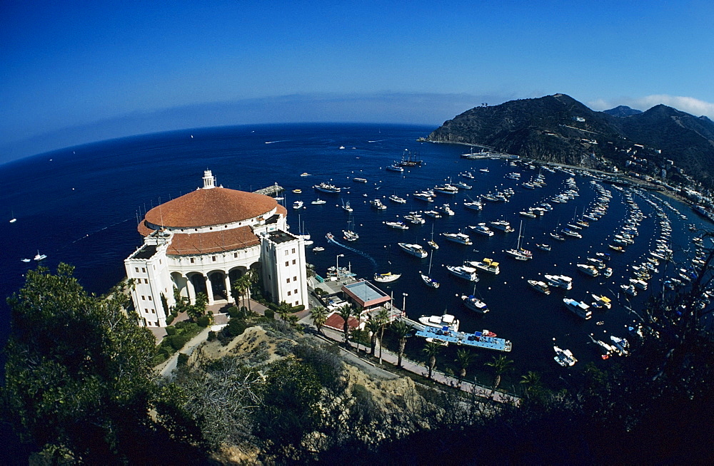 California, Catalina Island, Wide angle view of casino building and boats in harbor.