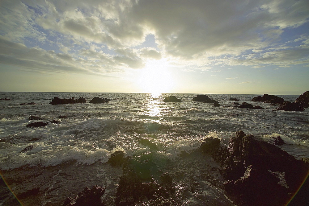 Hawaii, Big Island, Kohala Coast, Sunset and surf on rocks.