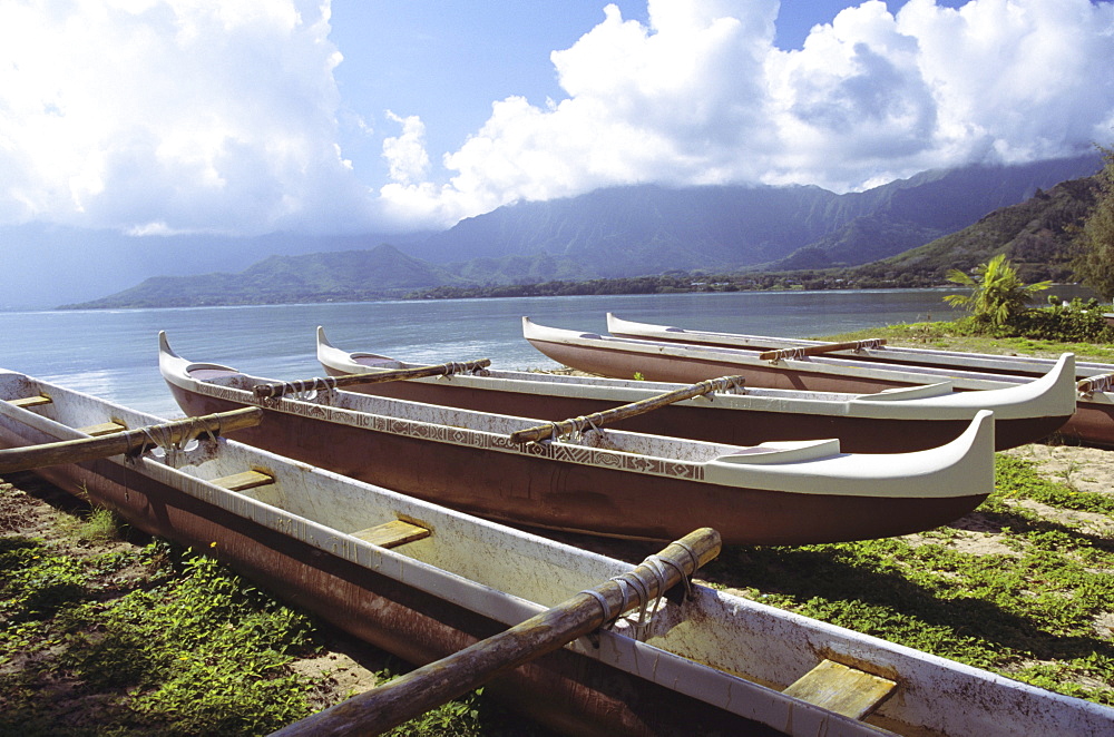 Hawaii, Oahu, Kaneohe Bay, Secret Island, Line of outrigger canoes on beach.