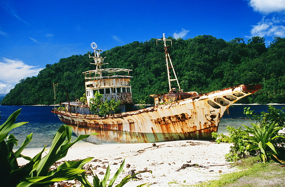 Papua New Guinea, Shipwrecked fishing boat on the beach.