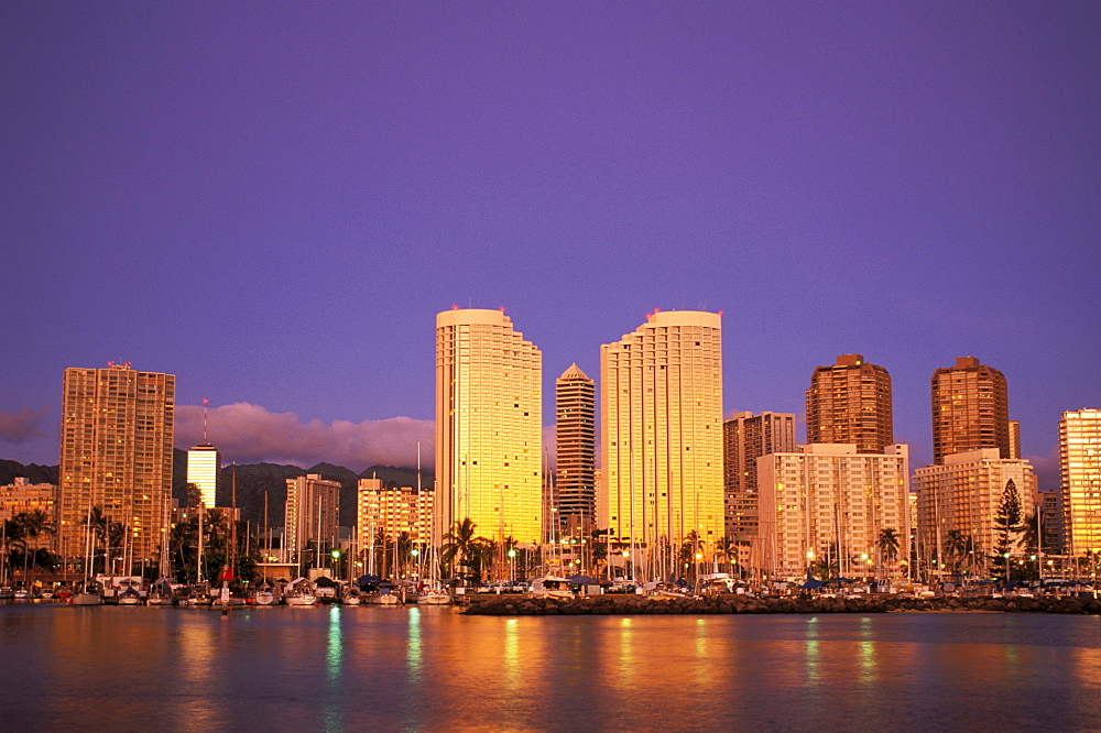 Hawaii, Oahu, Waikiki, Ala Moana skyline at twilight.