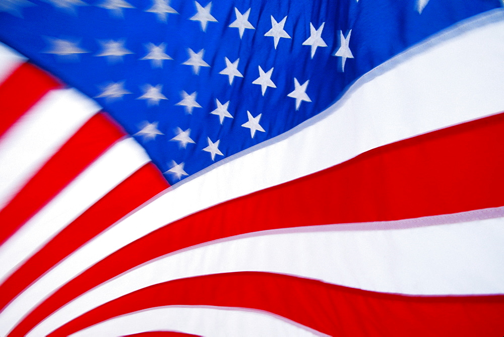 Extreme close-up of American flag star and stripes, motion