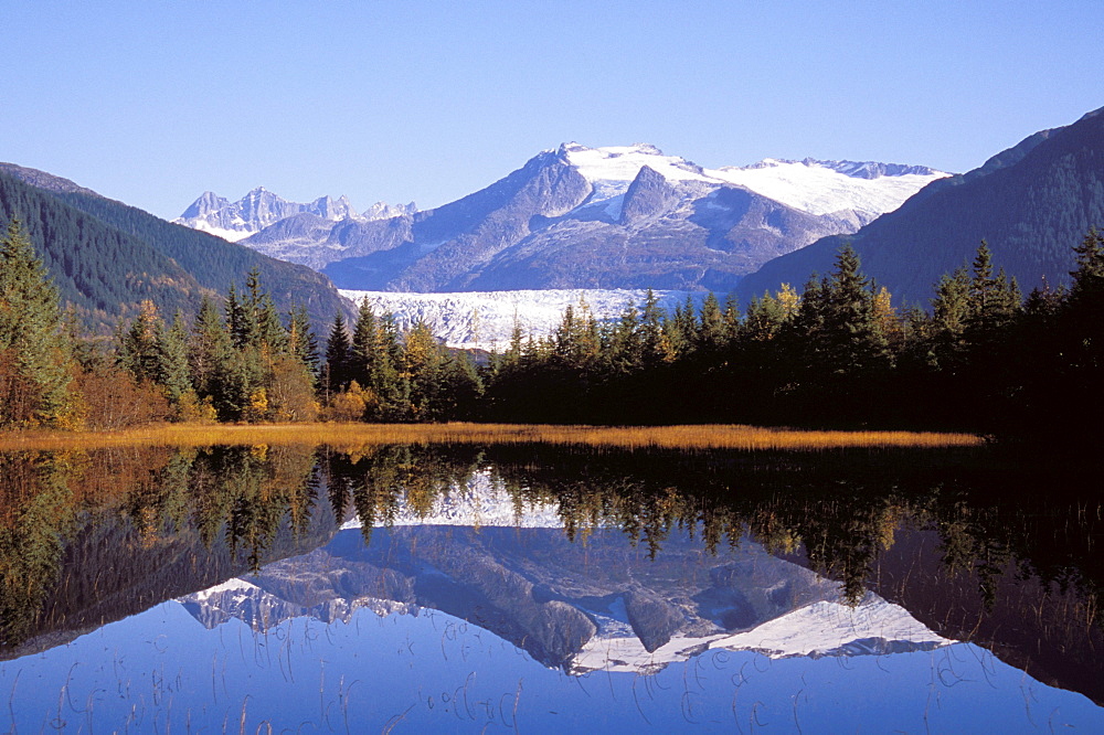 Alaska, Juneau, Mendenhall Glacier, Tongass National Forest, Mountains reflect in a mountain lake.