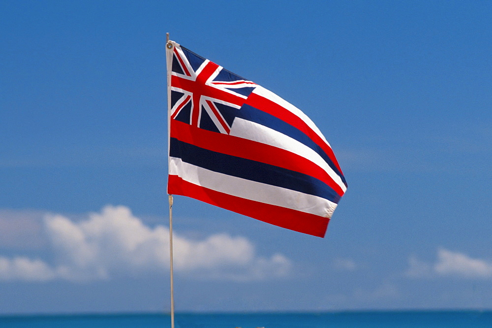 Hawaii, Hawaiian Flag, blue sky and clouds, ocean and horizon in foreground