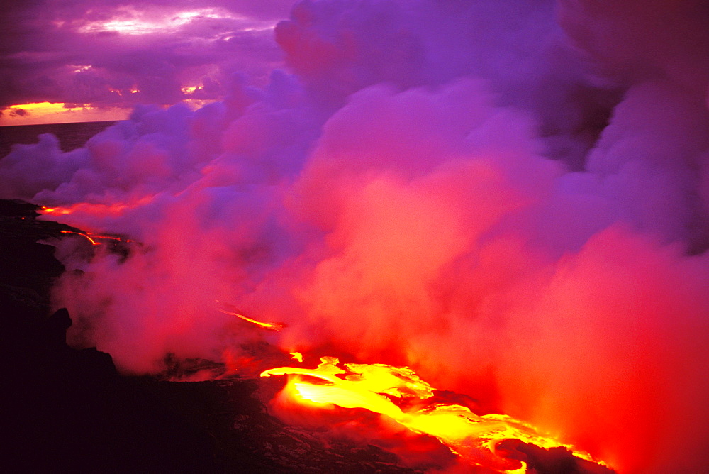 Hawaii, Big Island, Morning sky filled with pink and gray smoke, lava flow into ocean