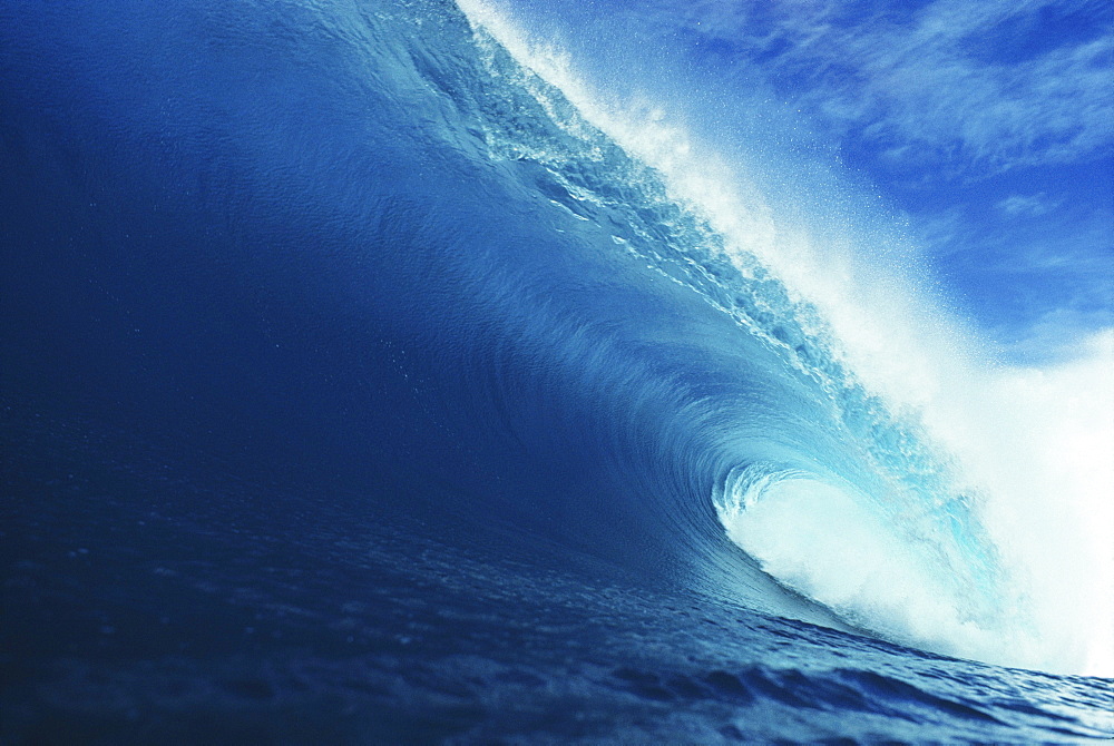 Hawaii, Close-up view of big blue tube, sky and clouds.