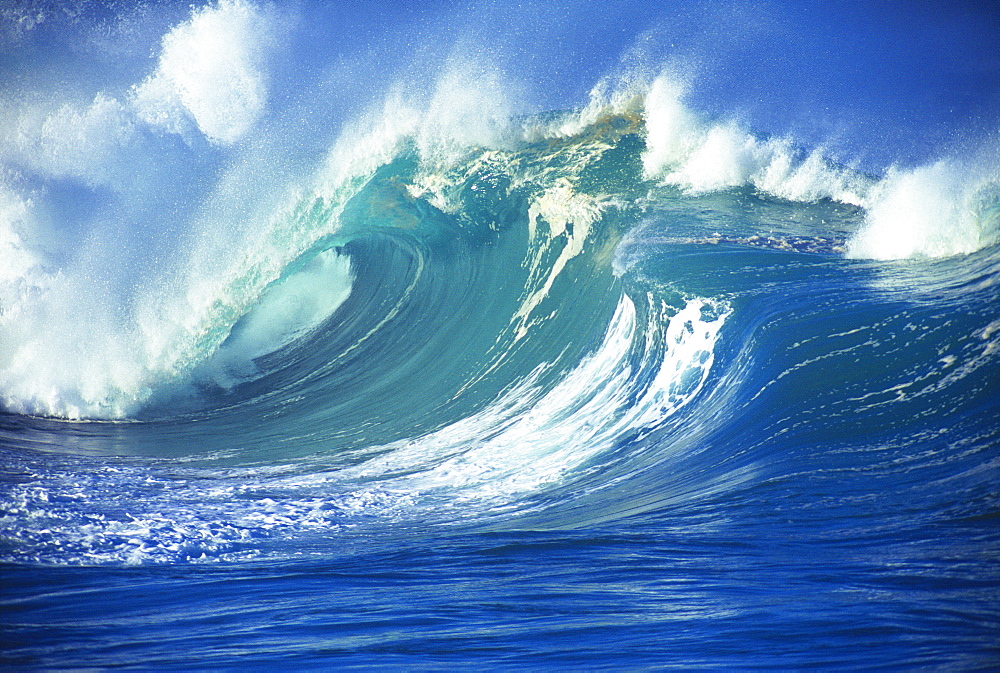 Stormy ocean wave curling over with whitewash and a barrel forming