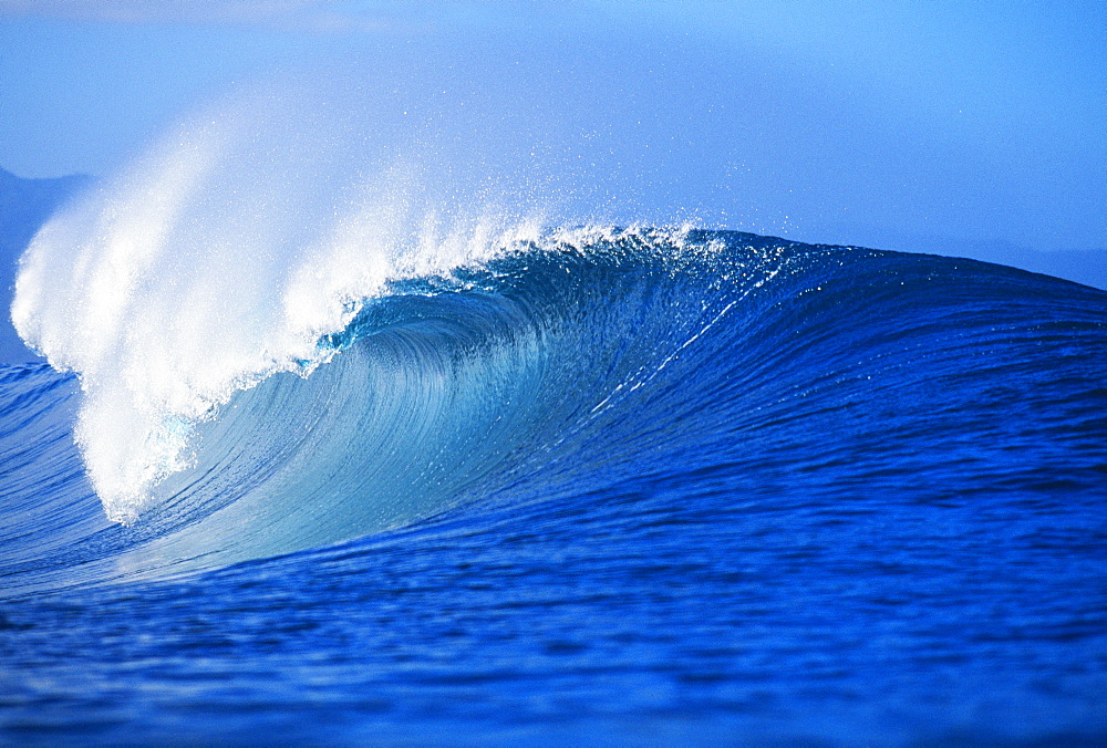 Hawaii, Oahu, North Shore, front angled view of Pipeline wave curling.