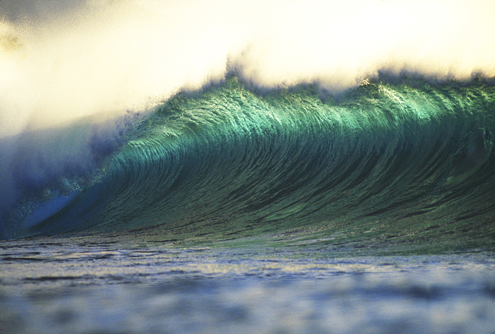 Hawaii, Oahu, North Shore, curling wave at world famous Pipeline at dusk.