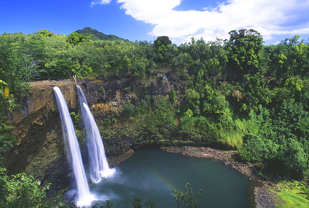 Hawaii, Kauai, Wailua Falls, 80 foot high waterfall cascading into deep pool.