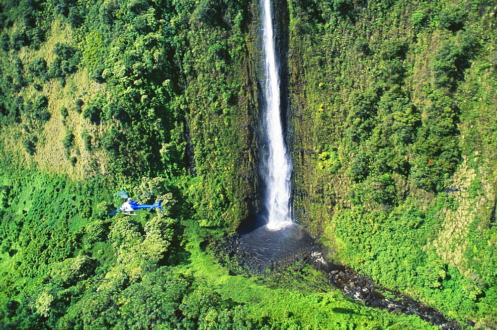 Hawaii, Big Island, Hamakua, distant view of large waterfall, helicopter in flight