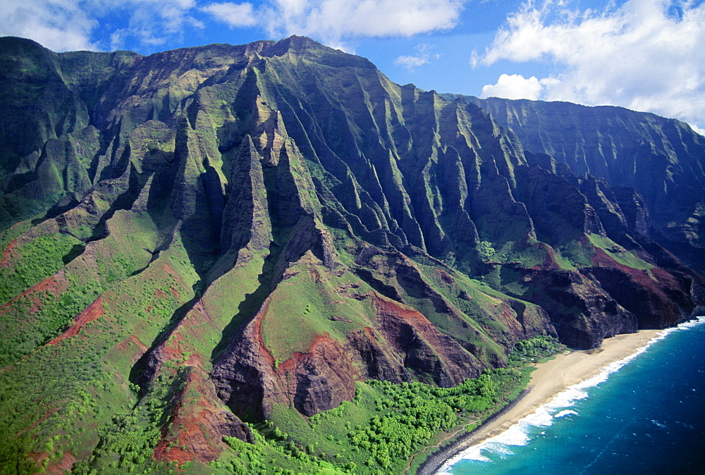 Hawaii, Kauai, NaPali Coast aerial along cliff, mountains with jagged cliffs, secluded beach