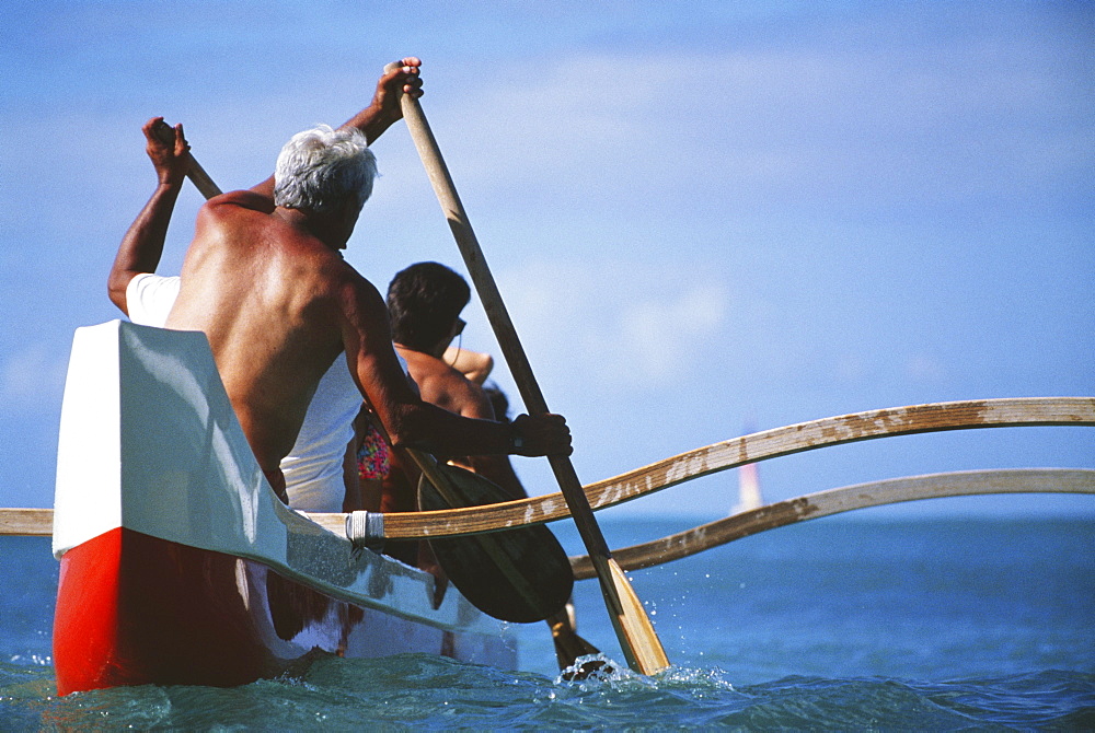 Outrigger canoe paddling, Close-up view from behind.