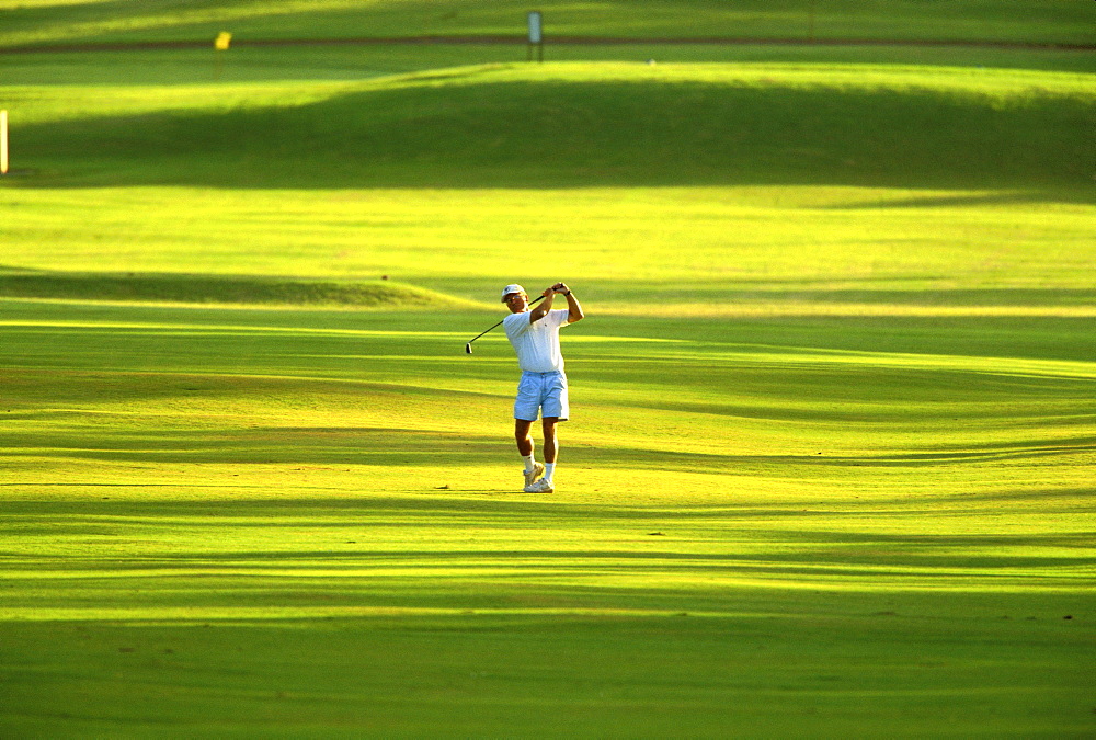 Hawaii, Maui, Spreckelsville Country Club, front view of Jim Bendon hits fairway iron