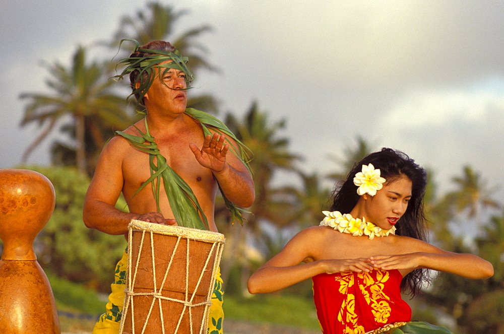 Hula at sunrise on beach with Tahitian Drummer dancing and playing with pride