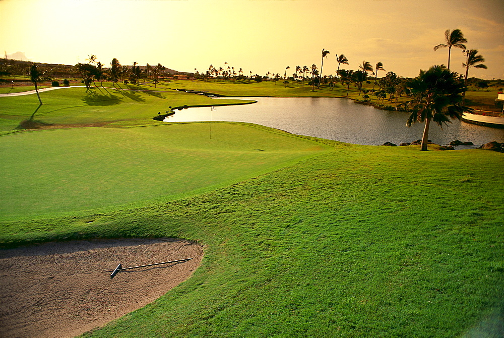 Hawaii, Oahu, Kapolei, Ko'Olina Golf Club, 18th hole at twilight, water hazard, sand trap 