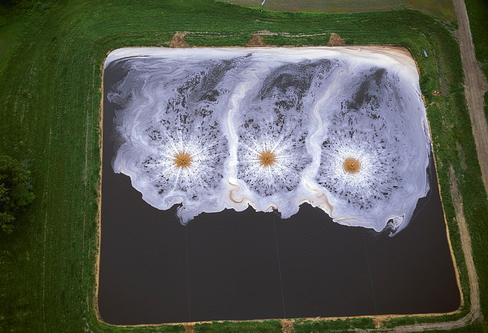 Livestock - Aerial view of an aeration pond, part of the waste treatment system at a poultry production facility / near Princeton, Missouri, USA.